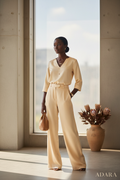Black woman wearing a timeless elegant ivory two-piece set
